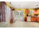 Bright kitchen featuring wooden cabinets, double doors to the backyard, and natural light at 2116 Sterling Creek Ln, Franklinton, NC 27525