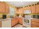 Well-lit kitchen featuring stainless steel appliances and wooden cabinetry at 2116 Sterling Creek Ln, Franklinton, NC 27525