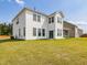 Exterior view of the back of the two-story white home showcasing the backyard and a screened porch at 218 Faith Avenue, Sanford, NC 27330