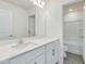 Bathroom with white cabinets, white countertop and large mirror at 218 Faith Avenue, Sanford, NC 27330