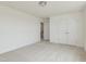 Bedroom with neutral carpet, white walls and two doors at 218 Faith Avenue, Sanford, NC 27330