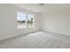 Bedroom with neutral carpet, white walls and two windows at 218 Faith Avenue, Sanford, NC 27330