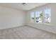 Bedroom with neutral carpet, white walls and three windows at 218 Faith Avenue, Sanford, NC 27330