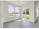 Bright dining area featuring large windows, wood floors, and a stylish chandelier at 218 Faith Avenue, Sanford, NC 27330