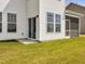 Exterior side view of home showcasing screened porch, windows, and sliding glass door at 218 Faith Avenue, Sanford, NC 27330