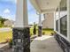 Inviting covered front porch of a home featuring stone pillars and manicured landscaping at 218 Faith Avenue, Sanford, NC 27330