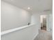 Hallway with neutral carpet, white walls and a bathroom at 218 Faith Avenue, Sanford, NC 27330