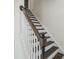 Staircase with dark wood steps and white risers at 218 Faith Avenue, Sanford, NC 27330