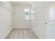 Well-lit walk-in closet with wire shelving and a window, offering practical storage at 218 Faith Avenue, Sanford, NC 27330
