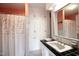Bathroom featuring decorative shower curtain, built in cabinets, and ample storage space at 219 E Nash St, Spring Hope, NC 27882