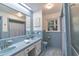 Charming blue-tiled bathroom with a double sink vanity and natural light at 219 E Nash St, Spring Hope, NC 27882