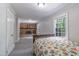 Cozy bedroom featuring a classic brick fireplace, two bright windows, and a comfortable bed at 219 E Nash St, Spring Hope, NC 27882