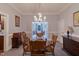 View of the dining room with chandelier above the wood table with wood chairs at 219 E Nash St, Spring Hope, NC 27882