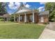 Charming brick home with inviting front porch and well-manicured lawn offers classic curb appeal at 219 E Nash St, Spring Hope, NC 27882