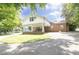 Brick home featuring a covered carport, concrete driveway, and well-maintained lawn at 219 E Nash St, Spring Hope, NC 27882