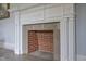 Close-up of a charming fireplace with decorative molding and brick detail at 219 E Nash St, Spring Hope, NC 27882