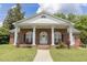 Charming brick home featuring a columned front porch and a well-manicured lawn at 219 E Nash St, Spring Hope, NC 27882