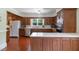 This kitchen features wood cabinets, stainless steel appliances, light countertops and an abundance of natural light at 219 E Nash St, Spring Hope, NC 27882