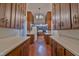 Features wood cabinets, tile floor, neutral countertops, and a view to a second kitchen area at 219 E Nash St, Spring Hope, NC 27882