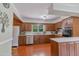 Cozy kitchen featuring wood cabinets, stainless steel appliances, and an abundance of natural light at 219 E Nash St, Spring Hope, NC 27882