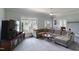 View of the living room with large couch and television at 219 E Nash St, Spring Hope, NC 27882