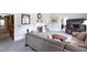 Spacious living room with a cozy fireplace, plush seating, and neutral decor at 219 E Nash St, Spring Hope, NC 27882