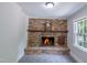 Living room featuring a brick fireplace, wooden mantle, and a classic design at 219 E Nash St, Spring Hope, NC 27882