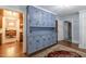 Stylish mud room with built-in blue cabinets offers ample storage space, tile flooring, and convenient access to the kitchen at 219 E Nash St, Spring Hope, NC 27882