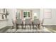 Bright dining area with modern table, chairs, and a view to the backyard at 221 Carova Bnd, Apex, NC 27539
