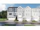 Charming townhome with a two-car garage, manicured lawn, and classic exterior at 221 Carova Bnd, Apex, NC 27539