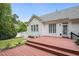 Spacious wooden deck overlooks the yard with white fence, offering a great outdoor space at 2311 Woodwyck Way, Raleigh, NC 27604
