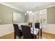 Inviting dining room featuring elegant wainscoting and plantation shutters at 2311 Woodwyck Way, Raleigh, NC 27604