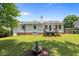 Well-maintained backyard with a fountain, lush lawn, and a deck at 2324 Hoskins Rd, Burlington, NC 27215