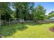 Expansive backyard featuring a swing set and mature trees at 2324 Hoskins Rd, Burlington, NC 27215