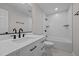 Well-lit bathroom featuring modern vanity, large mirror, and bathtub with shower at 2324 Hoskins Rd, Burlington, NC 27215