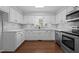 Modern kitchen featuring white cabinets, stainless steel appliances, and granite countertops at 2324 Hoskins Rd, Burlington, NC 27215