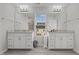 Bright bathroom featuring a double vanity, a large mirror, and tile flooring at 2346 Mckenzie Ridge Ln, Apex, NC 27502