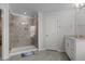 Bright bathroom featuring a glass enclosed tiled shower and single sink vanity at 2346 Mckenzie Ridge Ln, Apex, NC 27502