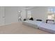 Bright bedroom featuring three windows, neutral carpeting, and tray ceiling at 2346 Mckenzie Ridge Ln, Apex, NC 27502