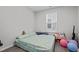 Cozy bedroom with floral bedspread, natural light, and comfortable sleeping space at 2346 Mckenzie Ridge Ln, Apex, NC 27502