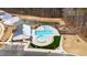 Aerial view of a community pool, pond, and playground surrounded by fencing and well-manicured grounds at 2346 Mckenzie Ridge Ln, Apex, NC 27502