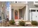 Charming front porch with an orange front door, offering a welcoming entry to the home at 2346 Mckenzie Ridge Ln, Apex, NC 27502