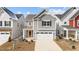 Beautiful two-story home with neutral siding, a two-car garage, and a welcoming, bright red front door at 2346 Mckenzie Ridge Ln, Apex, NC 27502
