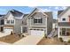Exterior view of a two-story home showcasing neutral siding, a two-car garage and well-manicured front lawn at 2346 Mckenzie Ridge Ln, Apex, NC 27502