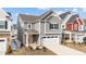 Charming two-story home with neutral siding, attached two-car garage, and an inviting red front door at 2346 Mckenzie Ridge Ln, Apex, NC 27502