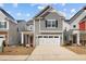 Charming two-story home with gray siding, white trim, two-car garage and a vibrant red front door at 2346 Mckenzie Ridge Ln, Apex, NC 27502