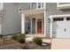 Charming home exterior with inviting front door, garage, and manicured landscaping at 2346 Mckenzie Ridge Ln, Apex, NC 27502
