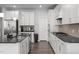 Modern kitchen featuring stainless steel appliances, generous island, and ample white cabinetry at 2346 Mckenzie Ridge Ln, Apex, NC 27502