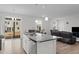 Bright kitchen with an island sink, modern appliances, and views to the living room and backyard at 2346 Mckenzie Ridge Ln, Apex, NC 27502