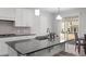 Beautiful kitchen with an island, stainless steel sink, and views of the back yard at 2346 Mckenzie Ridge Ln, Apex, NC 27502